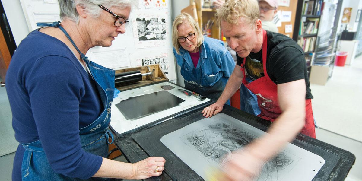 AACC art students learn to silkscreen.