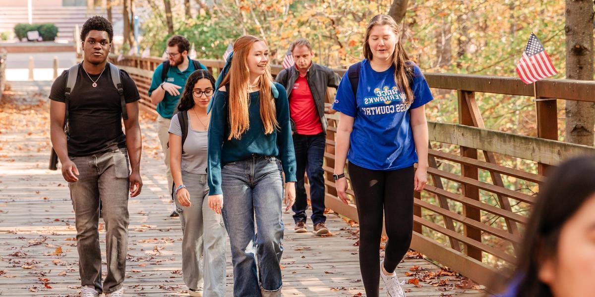 Students walking across bridge.